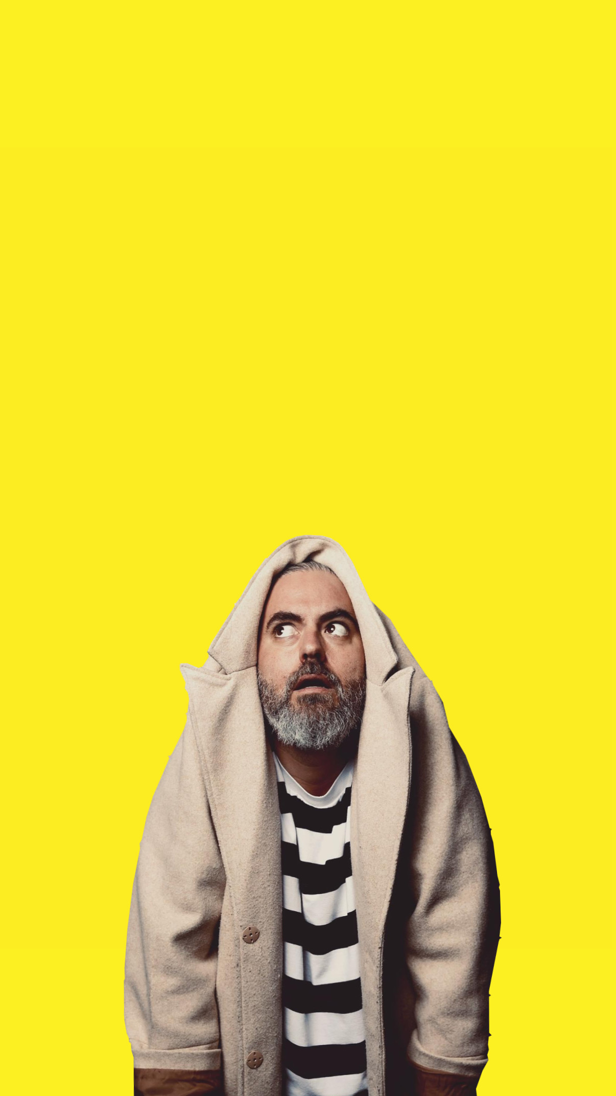 Joseph Llanes wearing a tan jacket draped over his head, looking upward.